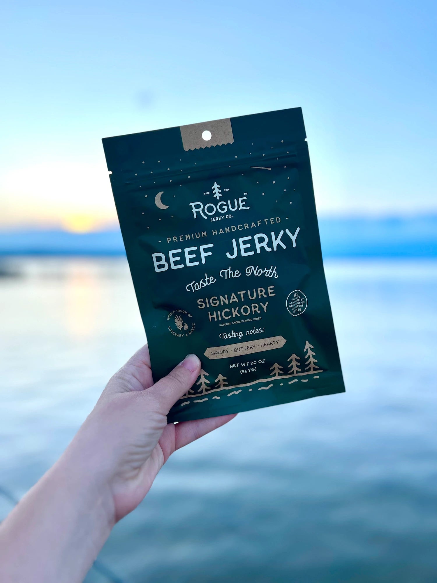 Rogue Jerky Signature Hickory Beef Jerky held above the water